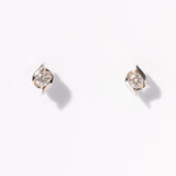 Pair of diamond stud earrings on a light gray background